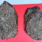 Two smoked beef briskets on a cutting board, both of which have excellent blackened bark and the pic is taken from above